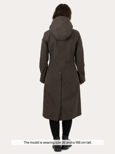 A woman viewed from the back wearing a Uhip Insulated ash brown raincoat paired with black leggings and black shoes. A text overlay at the bottom reads, 'The model is wearing size 36 and is 168 cm tall.