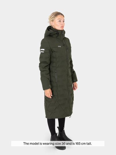 Woman wearing a Uhip Ice Coat in Dark Green on a white background