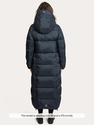 A model shown from the back wearing a Uhip arctic puffer coat extended  eclipse. The image has a text overlay at the bottom stating 'The model wearing size 36 and is 173 cm tall.
