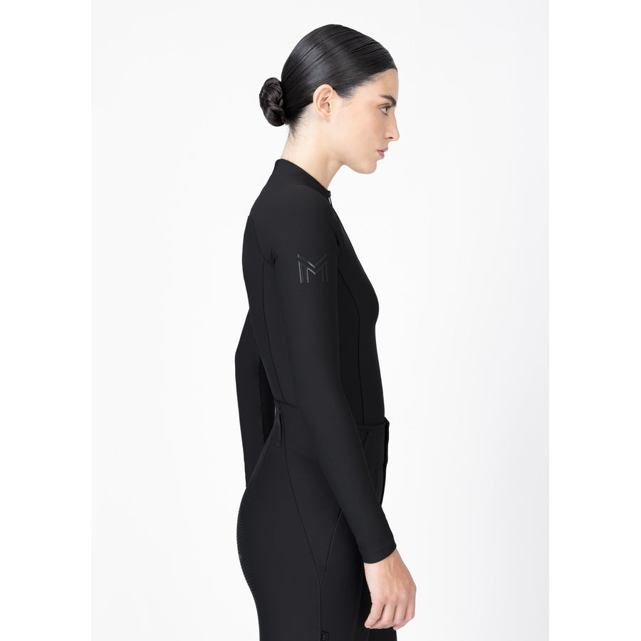 Upper back detail of women’s black technical riding base layer with signature logo at collar.